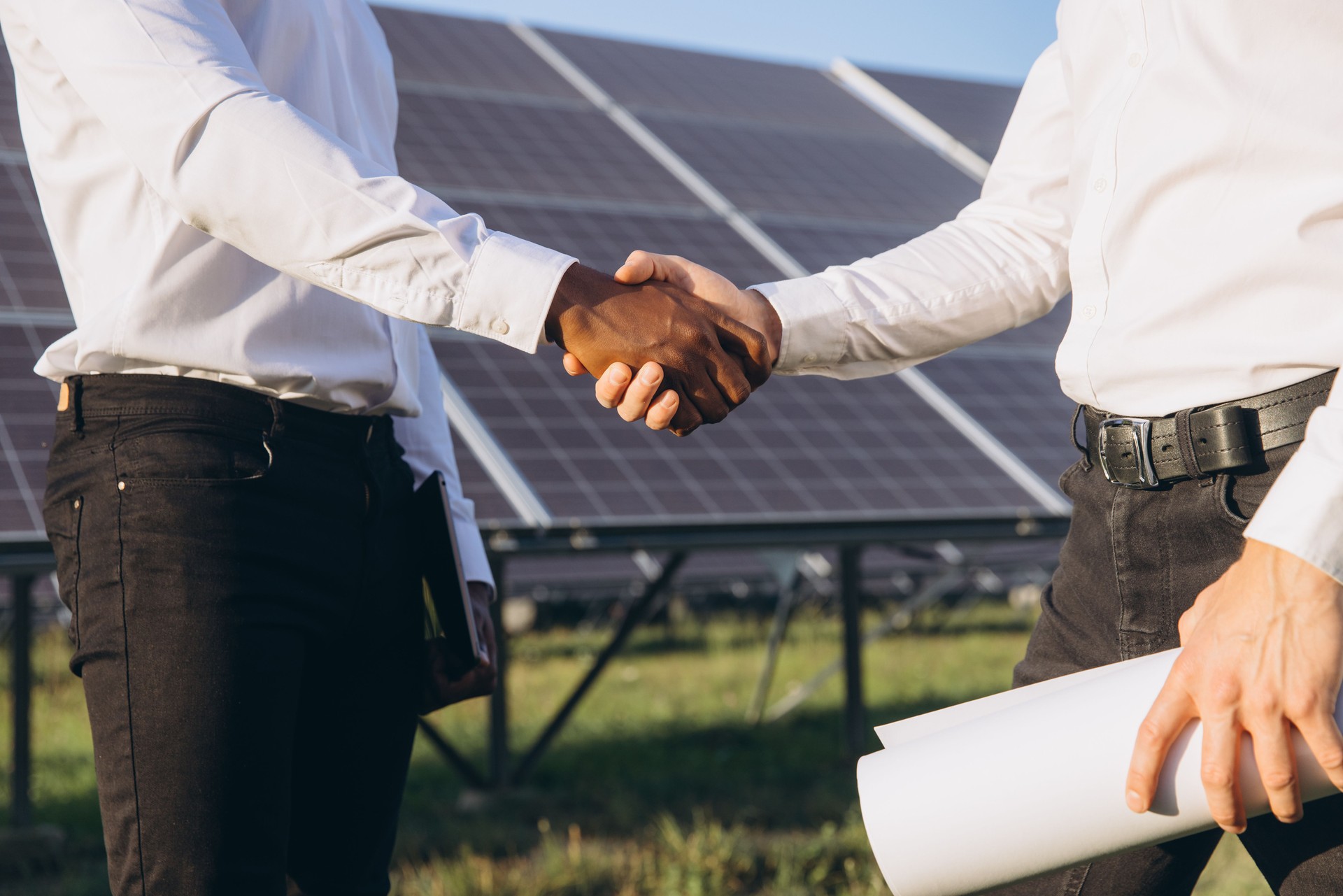 Businessmen Shaking Hands at Solar Power Plant